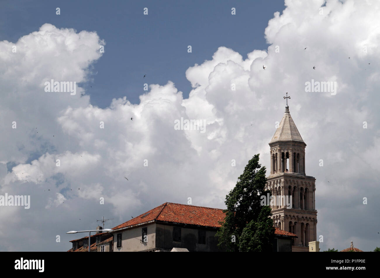 Dramatic clouds behind a church tower in Split, Croatia Stock Photo