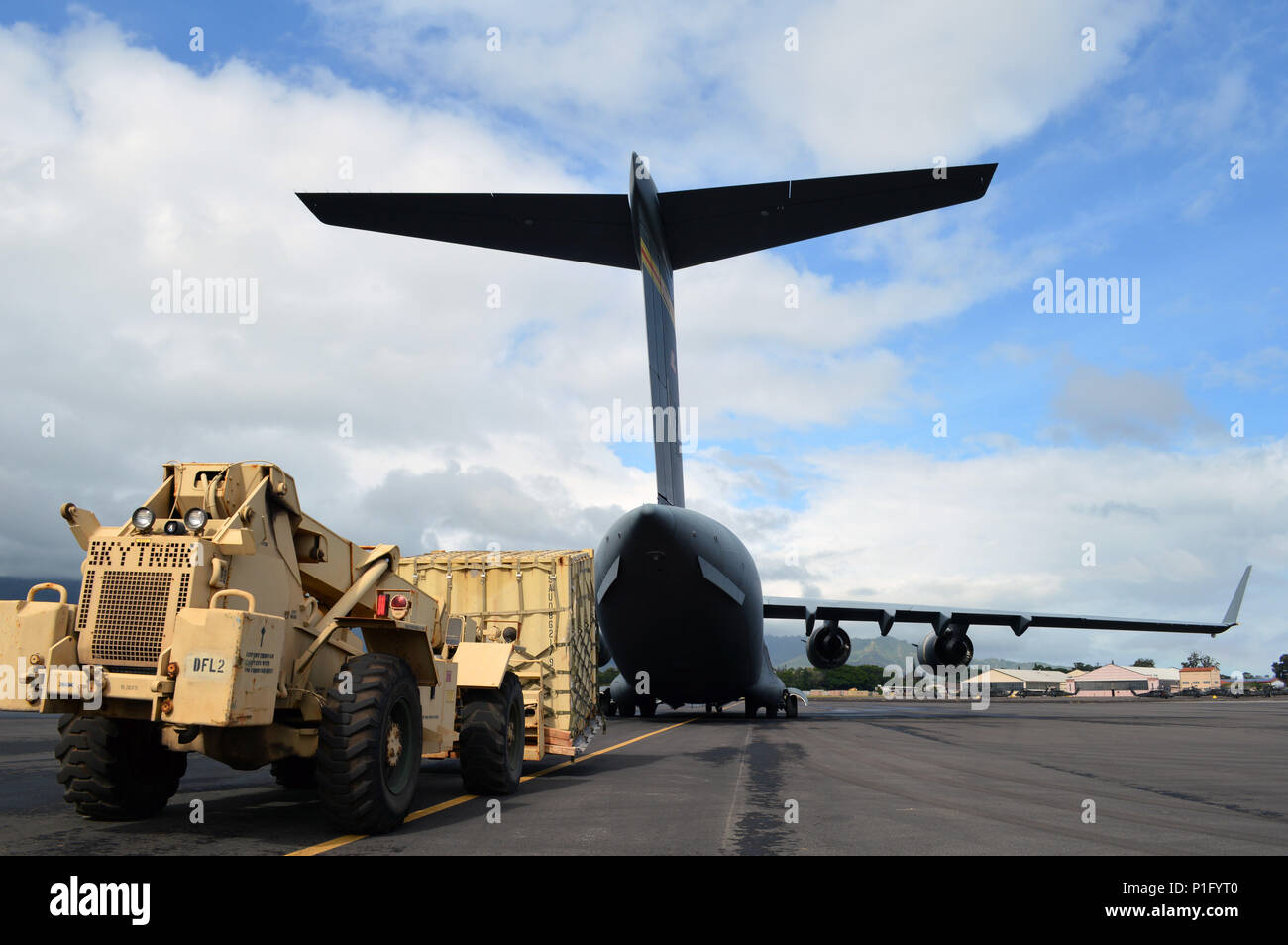 A forklift is readied to load a container aboard a C17 Globemaster III