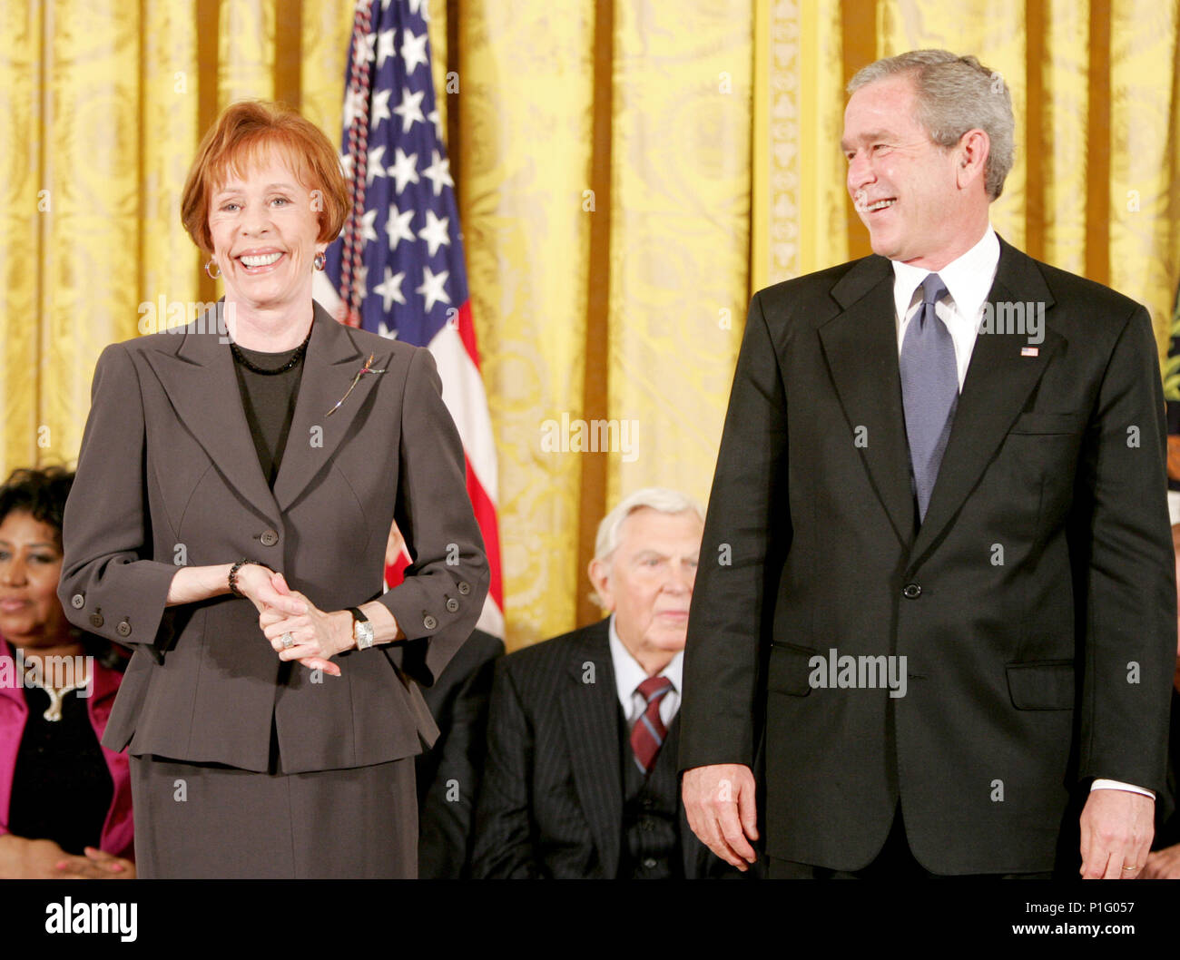 Carol Burnett jokes with President George W. Bush during the presentation of the Presidential Medal of Freedom to in the East Room Wednesday, Nov. 9, 2005. As a singer, dancer, comedienne, and actress, she has been one of America’s most cherished entertainers since her Broadway by in 1959. Photo by Paul Morse, Courtesy of the George W. Bush Presidential Library Stock Photo