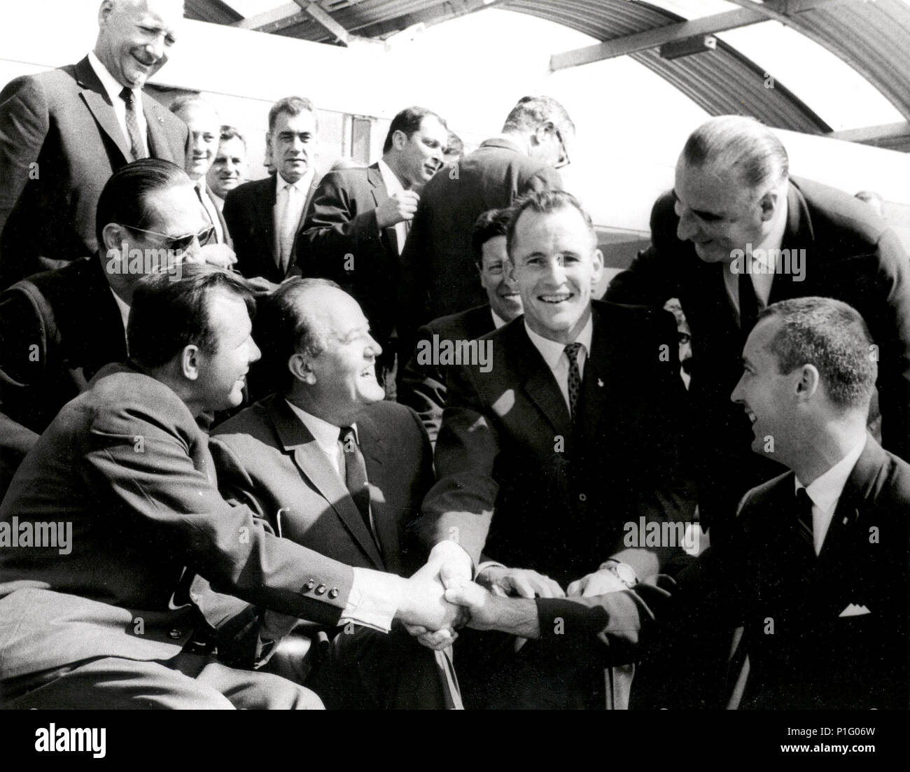 Soviet cosmonaut Yuri Gagarin shakes hand with NASA's Gemini 4 astronauts, Edward H. White II and James A. McDivitt at the Paris International Air Show in June 1965.  Also shown in the picture (seated) are Vice President Hubert H. Humphrey and (standing) French Premier Georges Pompidou. Stock Photo