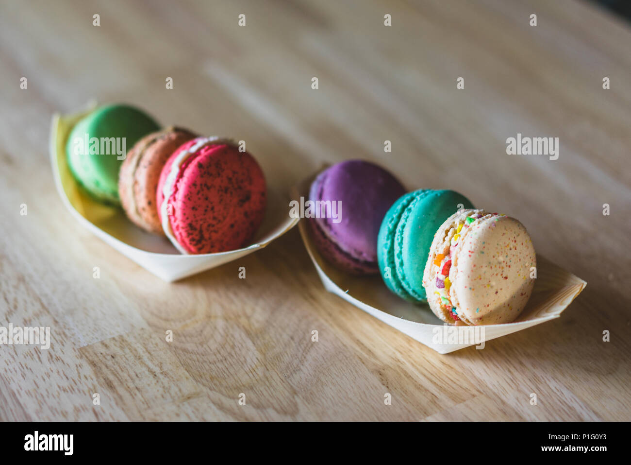 Different color macarons on a table Stock Photo