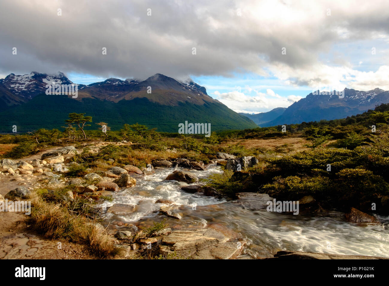 A small river descends near the Laguna Esmeralda. The valley and river offer beautiful views during a muddy hike. Stock Photo