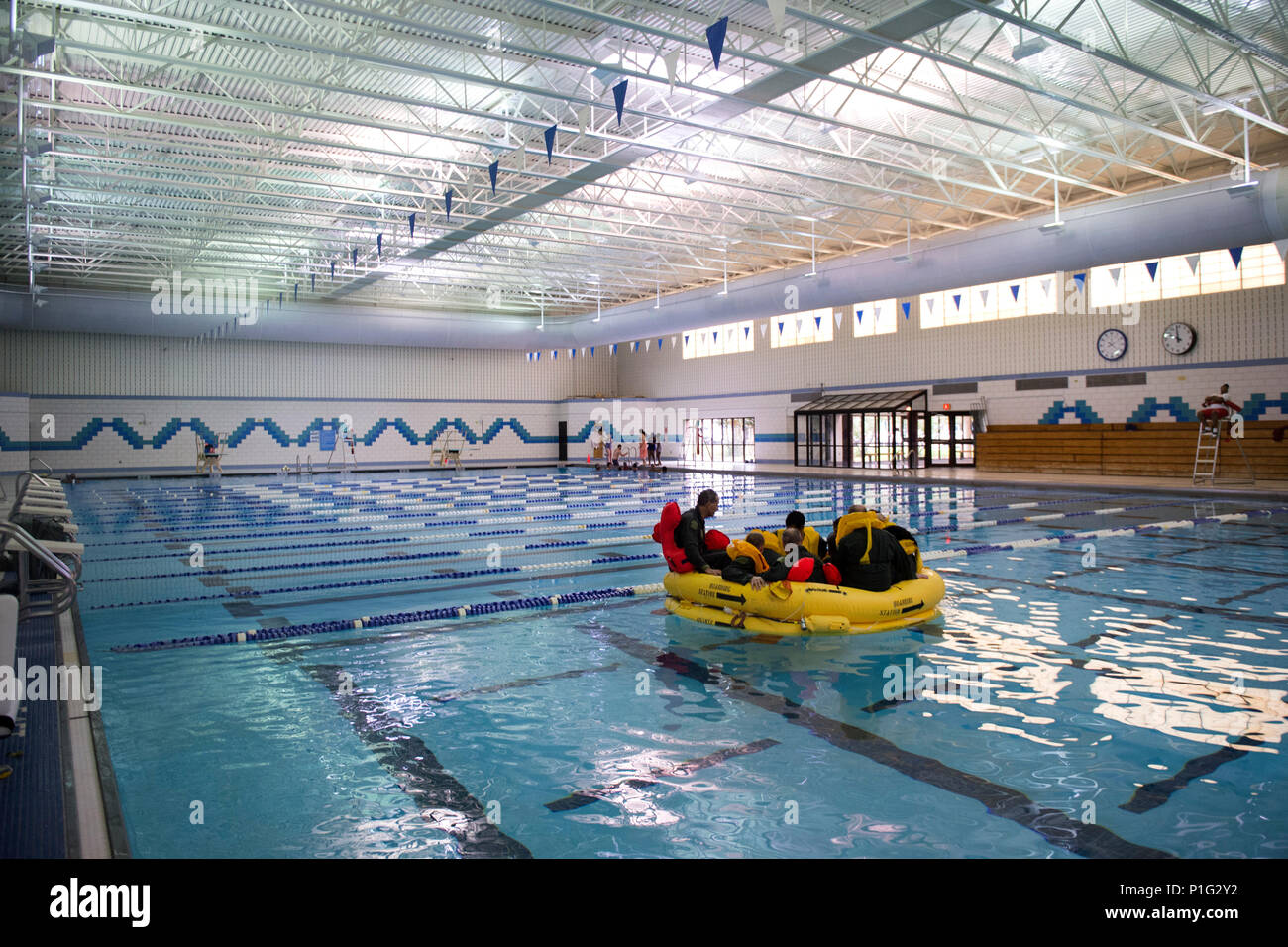 Flight crew members from the National Capital Region sit in a life raft ...