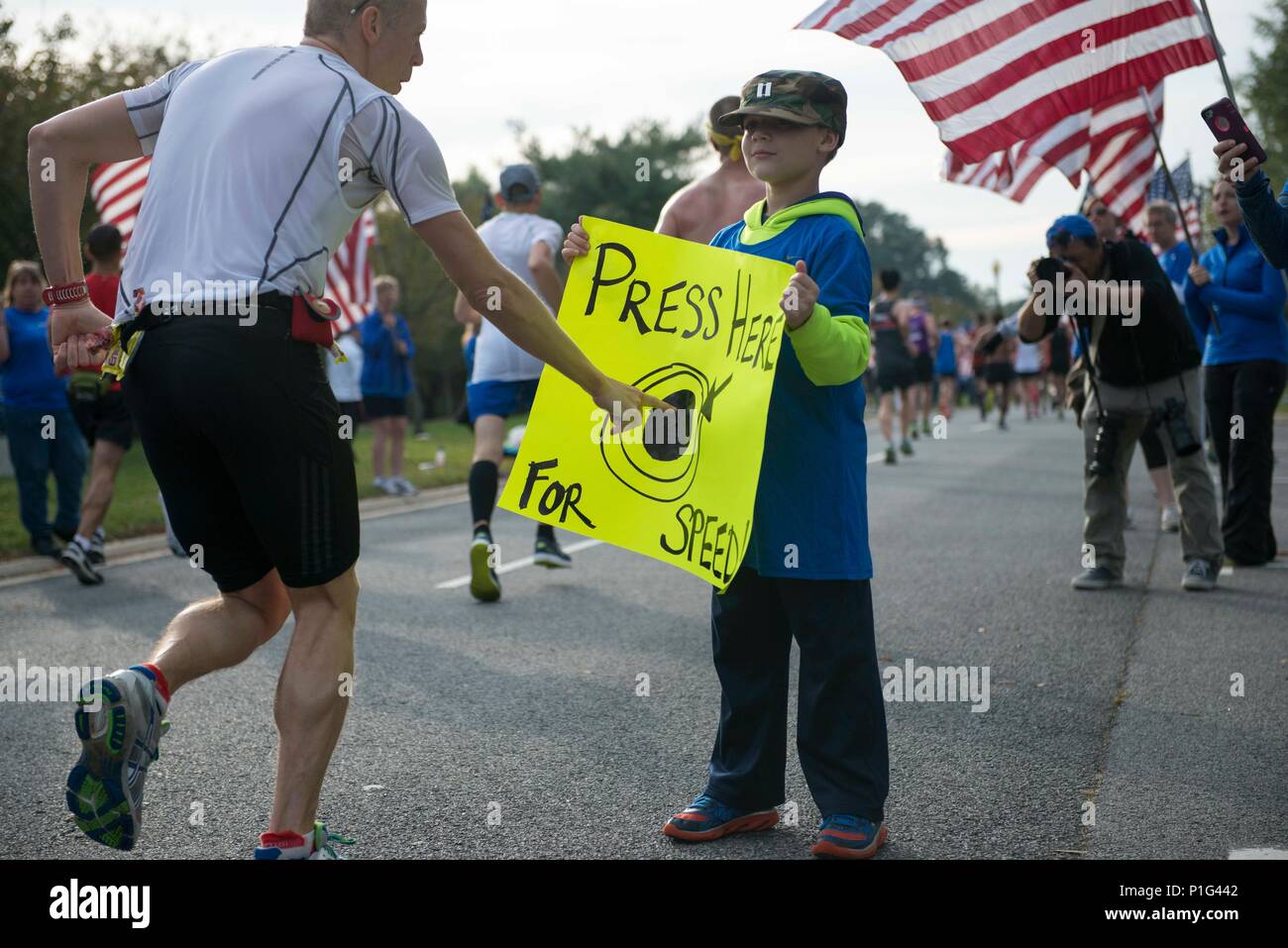 A Wear Blue: Run to Remember volunteer holds a sign to motivate runners  during the 41st Marine Corps Marathon, Oct. 30, in Washington. Wear Blue is  a volunteer running community that honors