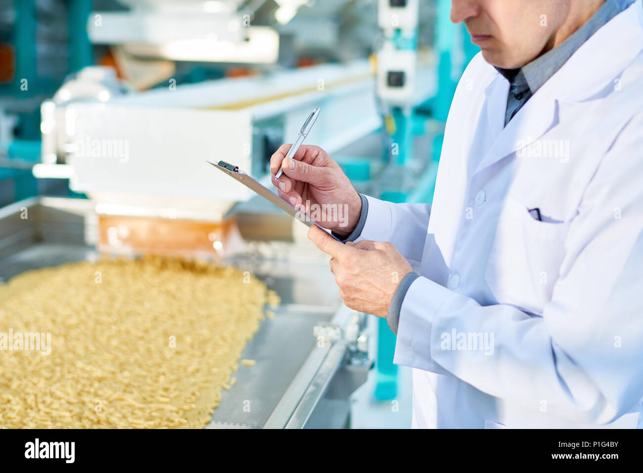 Factory Inspector Taking Notes Stock Photo