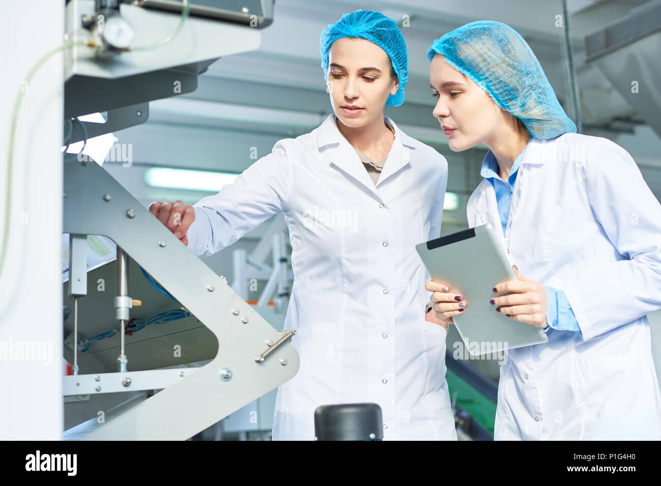 Female Workers at Modern Factory Stock Photo