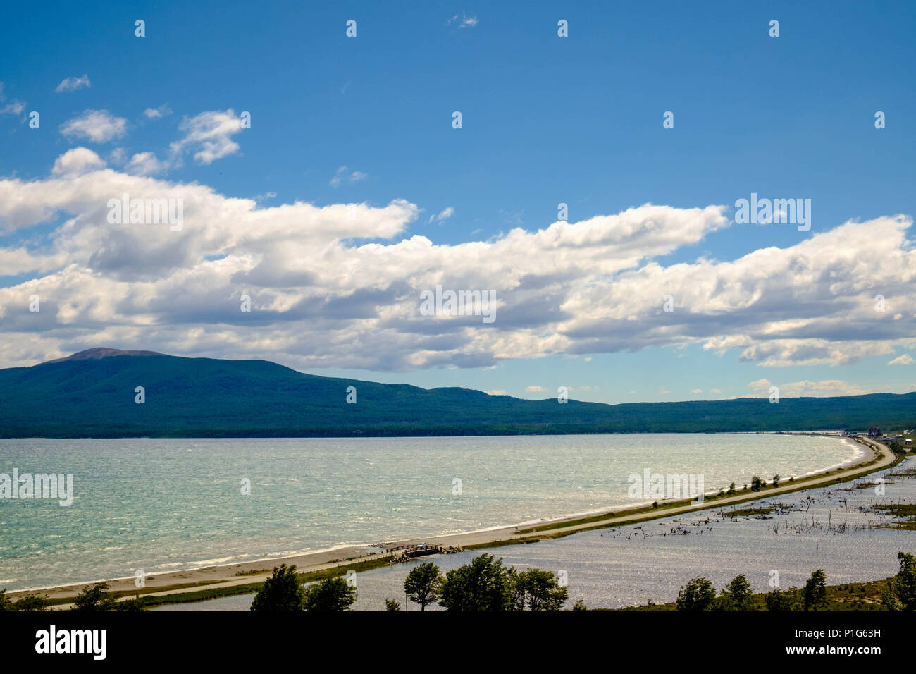 Lake Fagnano, also known as Cami Lake, is such a long stretch that it almost splits Tierra del Fuego. This is the coastline near Tolhuin. Stock Photo