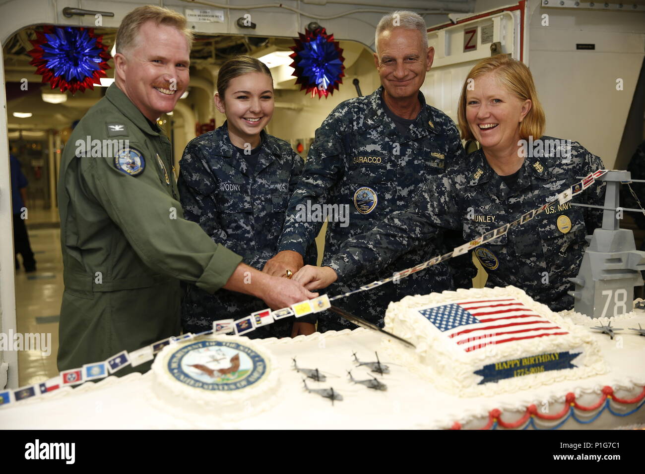 NEWPORT NEWS, Va. (Oct. 13, 2016) -- Capt. Richard McCormack, commanding officer of Pre-Commissioning Unit Gerald R. Ford (CVN 78), Seaman Kaitlyn Zavodny, Capt. Gregory Saracco, and Master Chief Petty Officer Laura Nunley, Ford's Command Master Chief, cut the ceremonial cake commemorating the U.S. Navy's birthday.  Ford Sailors celebrated the Navy's 241st birthday with a special lunch prepared by the ship's culinary team. (U.S. Navy photo by Petty Officer 3rd Class Sean Elliott/Released) Stock Photo