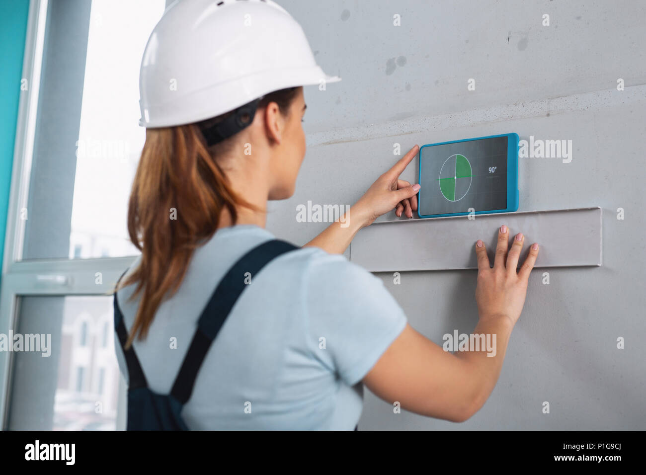 Female skilled builder working with her tools Stock Photo