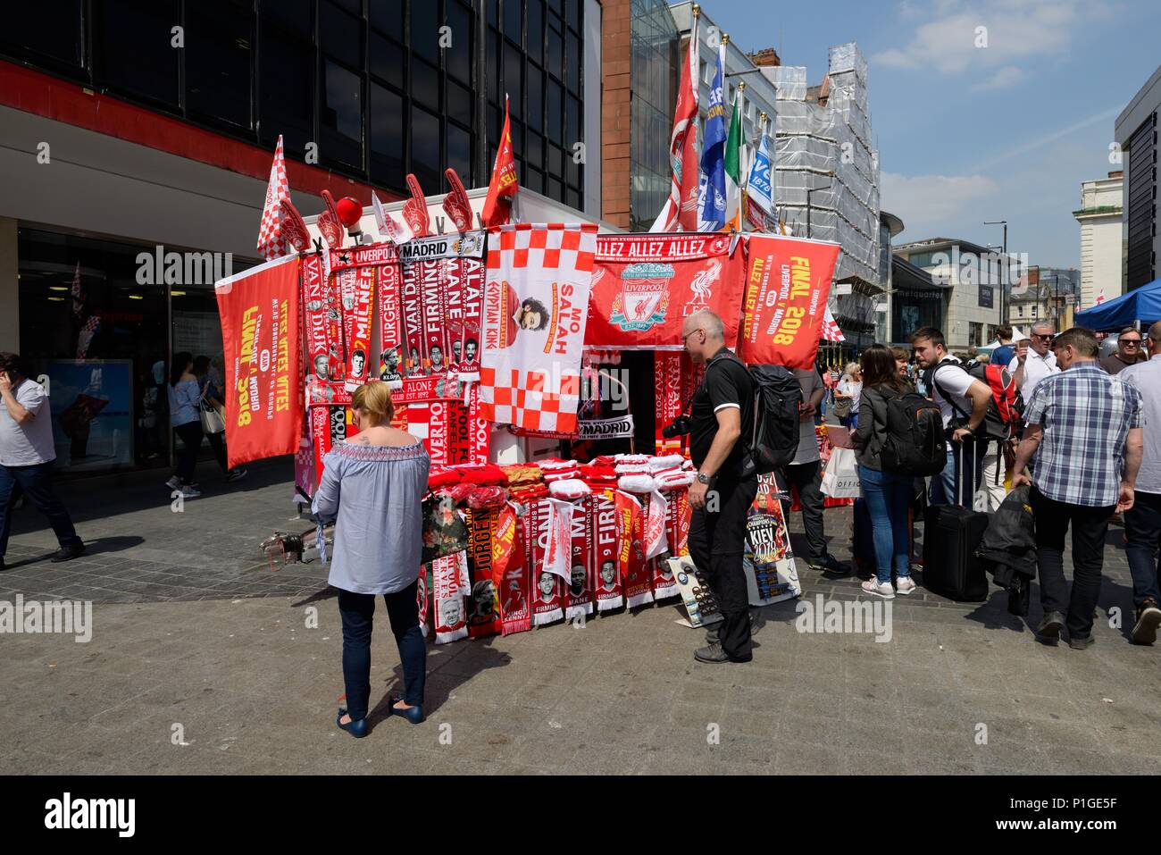 A trader operating a Liverpool football club merchandise stall in Liverpool city centre, England, UK Stock Photo
