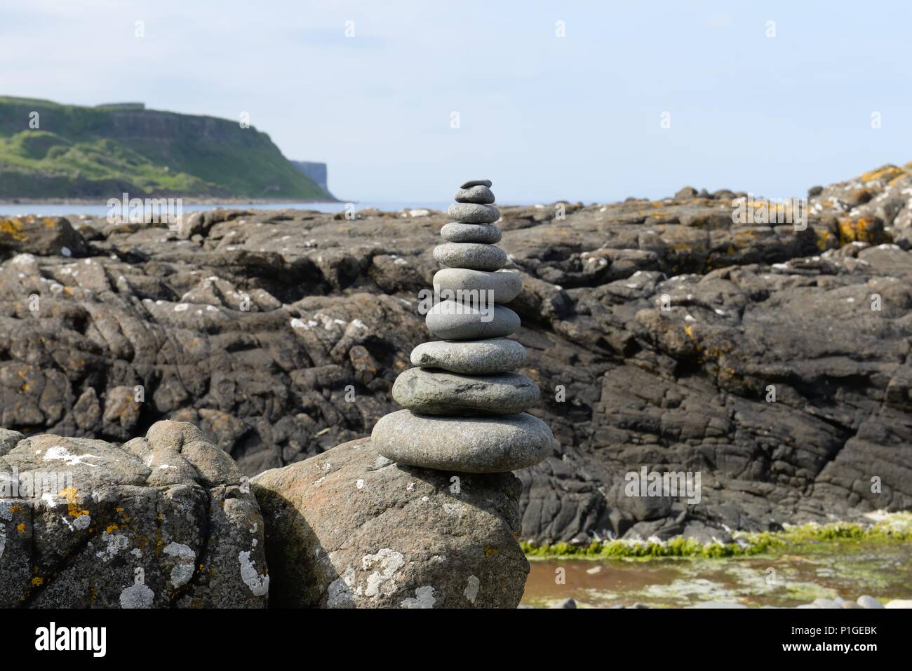 Stone stacking art on the rocky shoreline of Skye, Scotland, UK Stock Photo