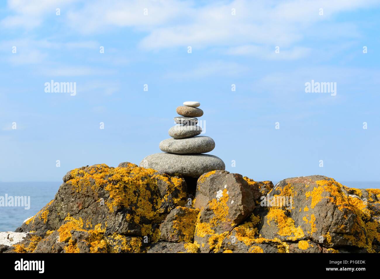 Stone stacking art on the rocky shoreline of Skye, Inner Hebrides, Scotland, UK Stock Photo