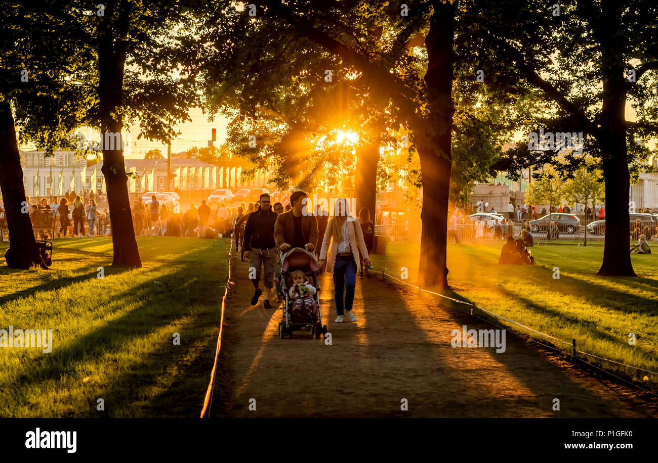 Family spend weekend in the city park on sunset. Stock Photo