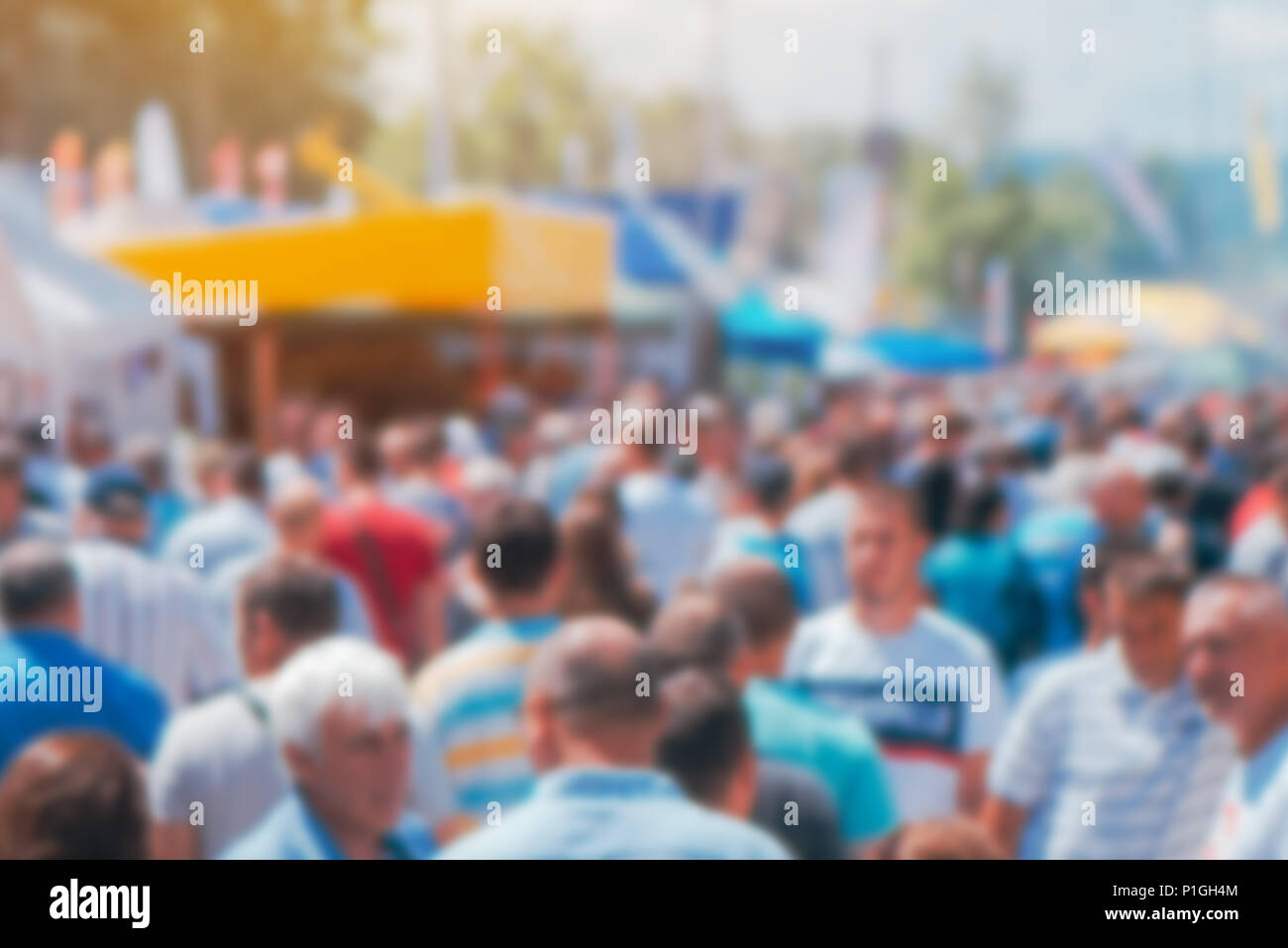 Abstract tradeshow blurry background with crowd people out of focus. Crowded outdoor open air festival show exhibition backdrop. Stock Photo