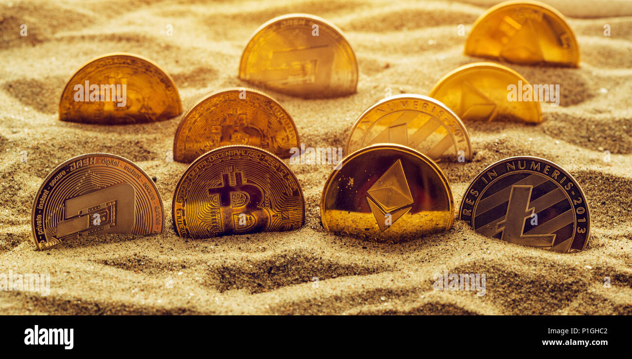 Cryptocurrency coins in sand, conceptual image for lost and found valuables  that are standing the test of time Stock Photo - Alamy