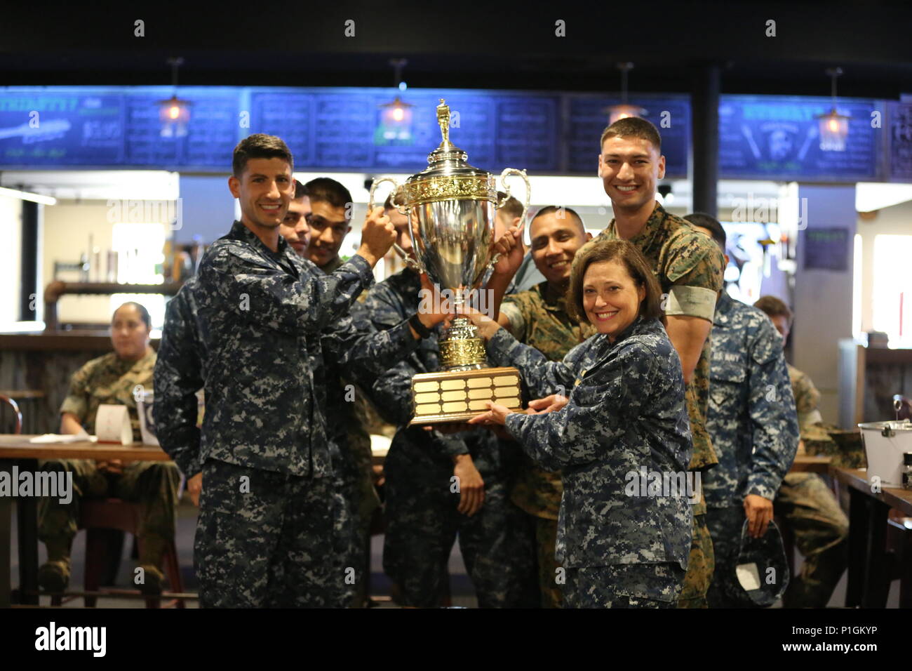 The Naval Health Clinic Cherry Point soccer team, along with Navy Capt. Angela Nimmo, celebrates winning the coveted Cherry Point intramural sports trophy aboard Marine Corps Air Station Cherry Point, N.C., Oct. 27, 2016. Cherry Point’s Semper Fit program annually re-awards the trophy to the unit aboard the air station that wins the most championships throughout the year. Some of the sports they participated in include softball, basketball, football and soccer. Nimmo is the Naval Health Clinic Cherry Point commanding officer. (U.S. Marine Corps photo by Lance Cpl. Mackenzie Gibson/Released) Stock Photo