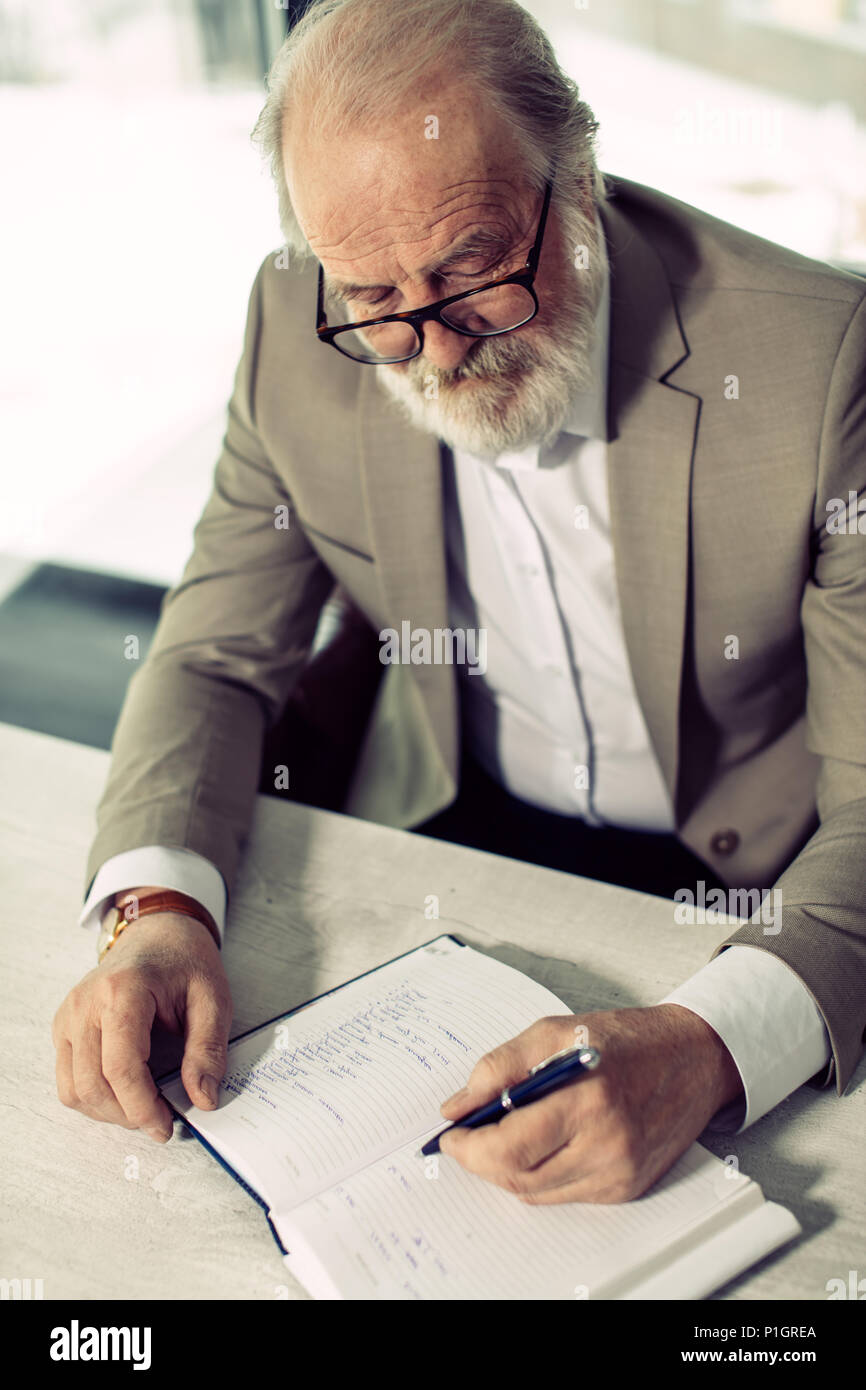 closeup top view photo of grey-headed senior writer with pen Stock ...