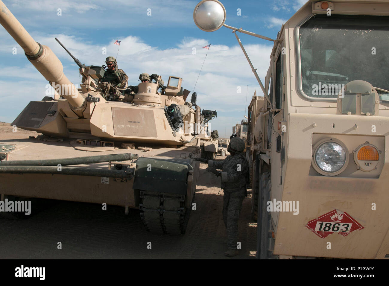 U.S. Soldier M1A2 Abrams tank crews from the 3rd Battalion, 8th Cavalry Regiment, 3rd Armored Brigade Combat Team, 1st Cavalry Division roll through a fuel point during the live-fire portion of the brigade's during National Training Center 17-01 at Fort Irwin, Calif., Oct. 13, 2016. NTC 17-01 provides U.S. military units and personnel with realistic pre-deployment training scenarios in all aspects of armed conflict. (U.S. Army photo by Staff Sgt. Leah Kilpatrick) Stock Photo