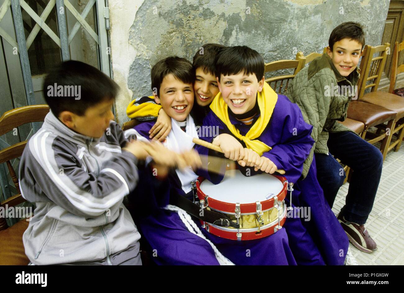 Hellín; Hellín; children with religious dressing playing drums during Holy Week / 'tamborada' (big drums procession). Stock Photo