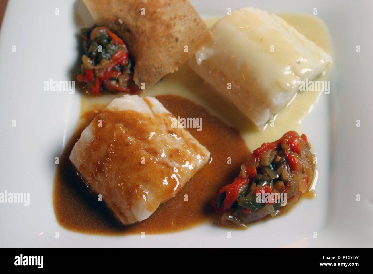 Ajo; restaurante / posada "La Casona de la Peña"; bacalao en salsas de pimientos choriceros y pil pil. Stock Photo