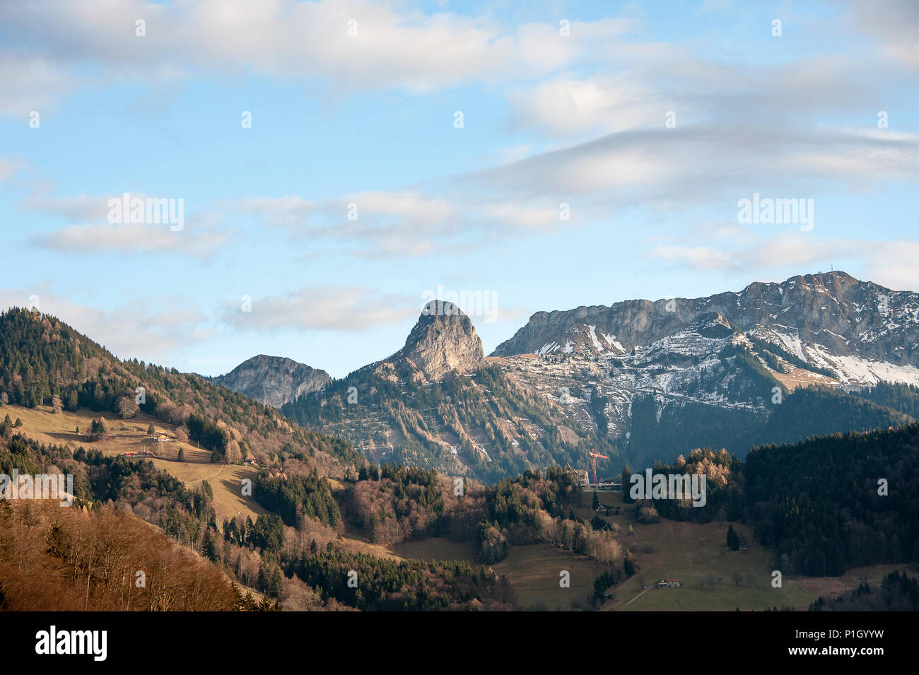 Panoramic view of snow capped mountain peaks , Col de Jaman, Switzerland. Beautiful landscape, autumn colours, forested slopes and a soft blue sky Stock Photo