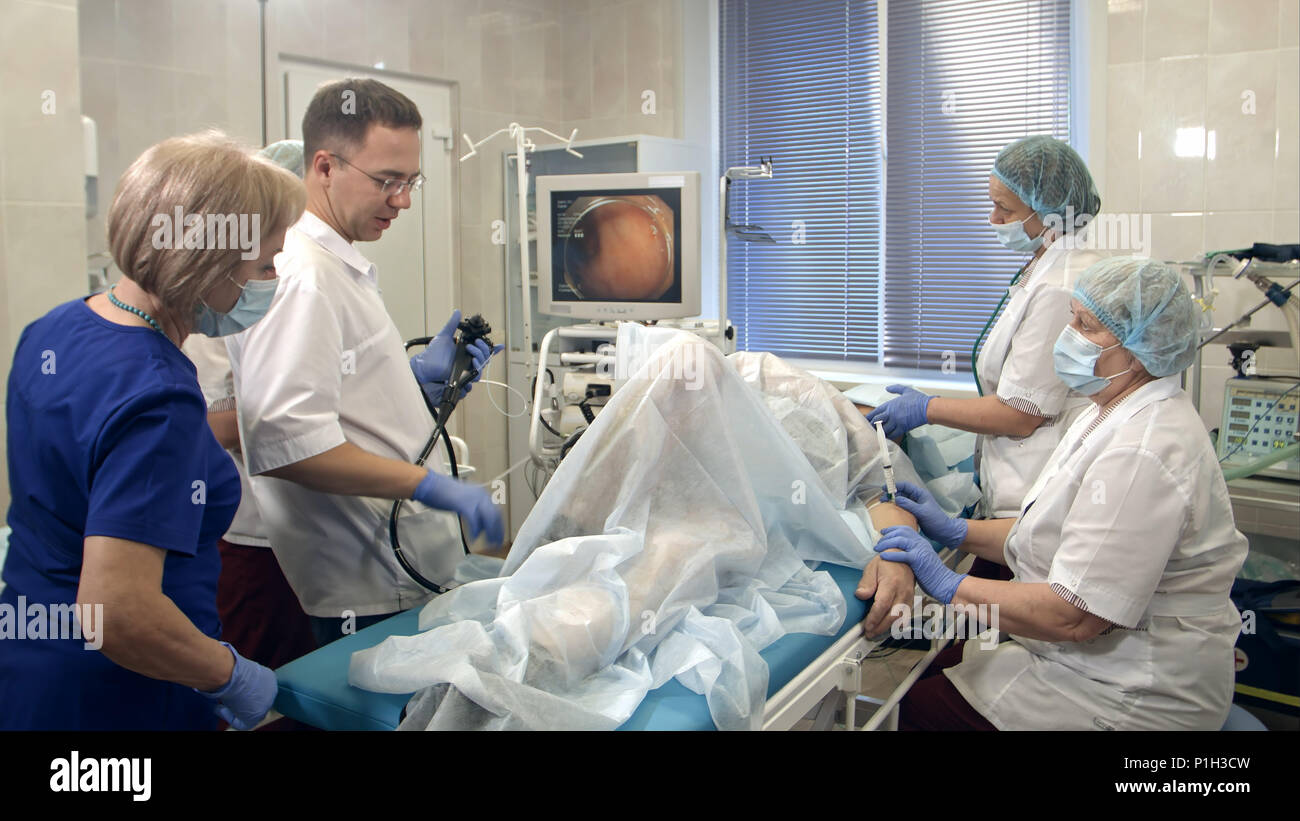 Doctors conducting procedure in endoscopy room Stock Photo Alamy