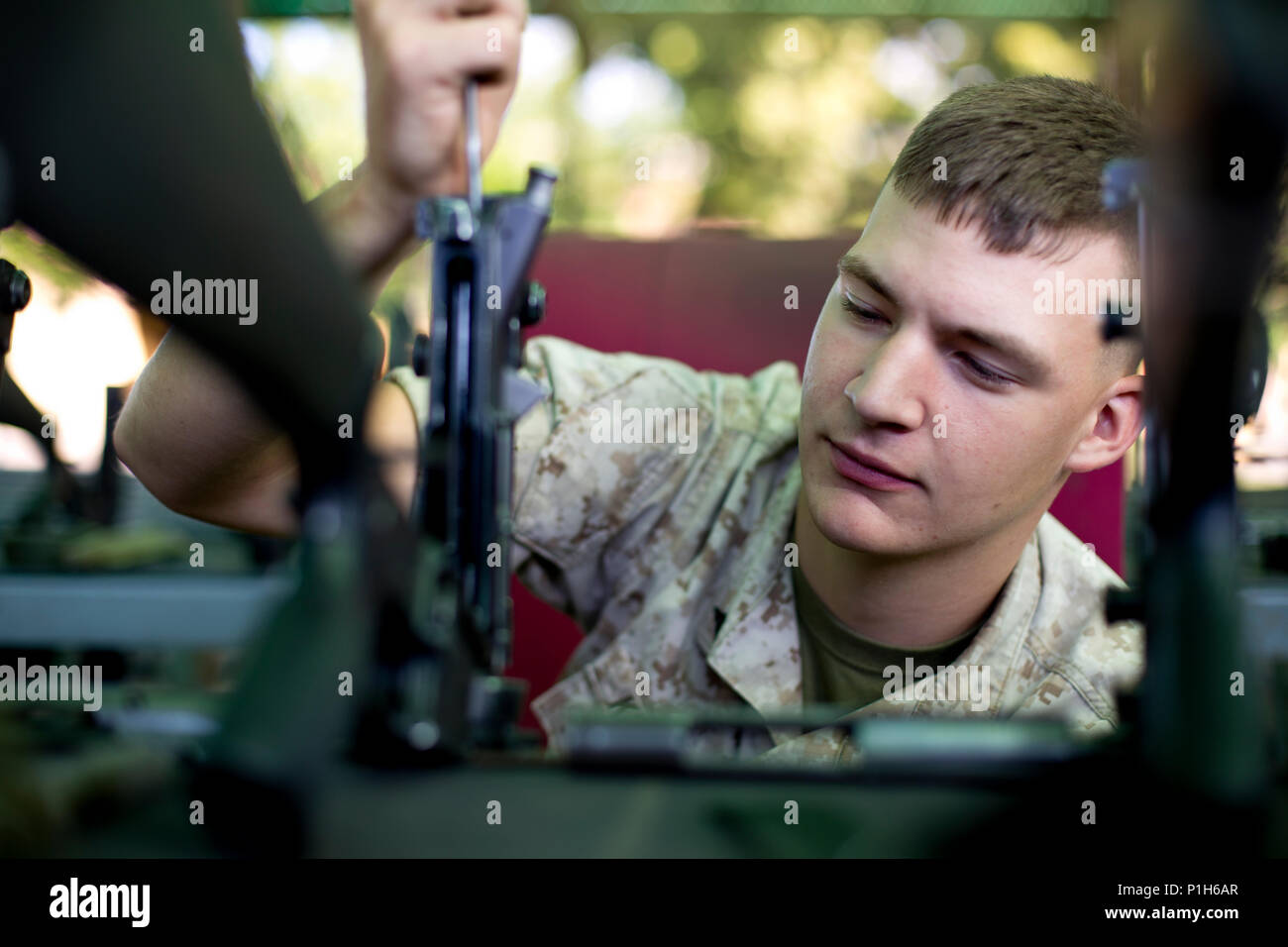 U.S. Marine Corps Lance Cpl. Kelly R. Keating, a small arms technician with the Armory, Service Company, Headquarters and Service Battalion, inspects a M16A4 rifle at Marine Corps Recruit Depot San Diego, Calif., Oct. 25, 2016. Keating ensured that the upper receiver of each rifle was returned in a serviceable condition. (U.S. Marine Corps photo by Lance Cpl. Robert G. Gavaldon) Stock Photo
