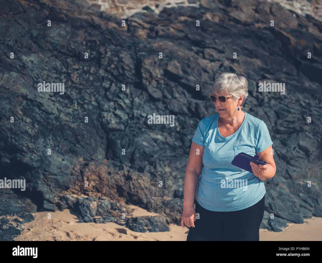 Mature woman beach mobile phone hi-res stock photography and images - Alamy