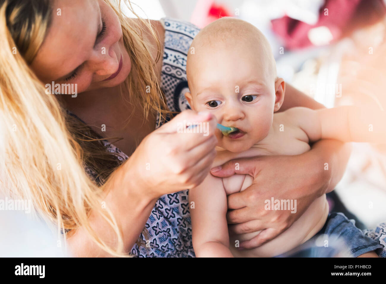 mother feeding her baby girl by spoon Stock Photo - Alamy