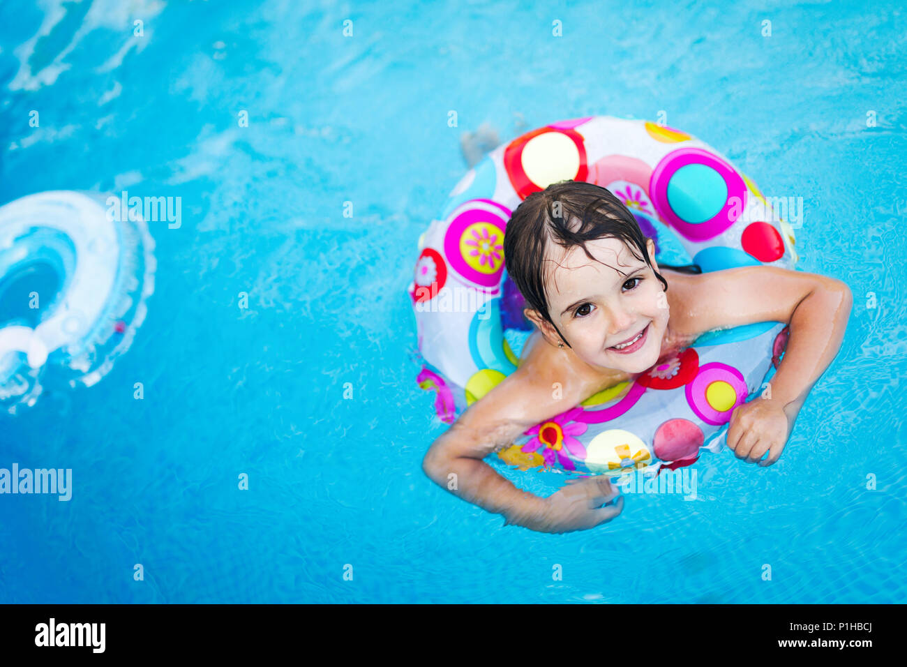 Little girl in swimming pool with float ring Stock Photo Alamy