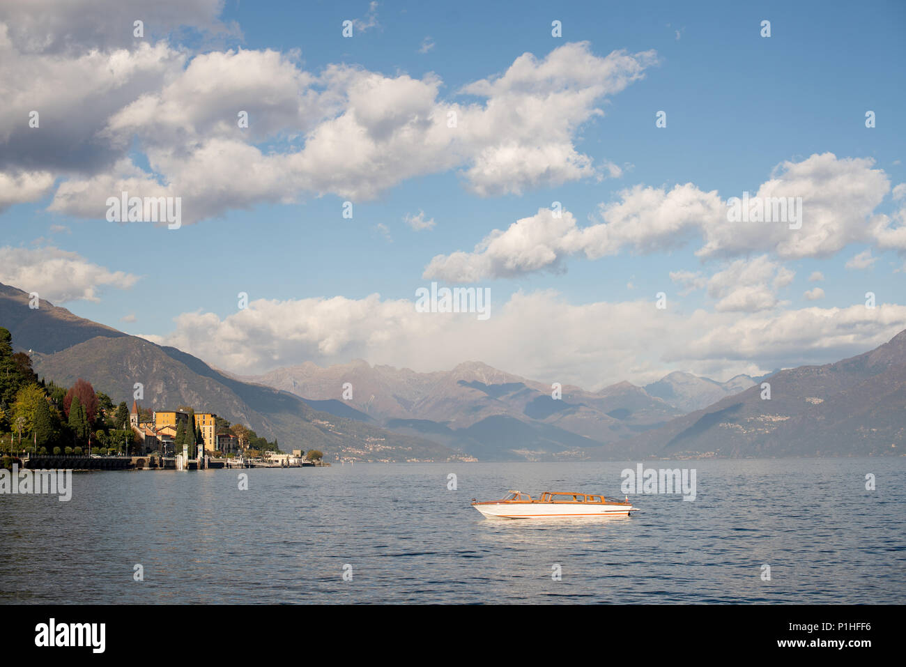Boat on Como Lake, Italy. Panoramic View with Alps on Background. Stock Photo