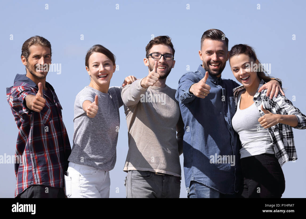 group of young people showing thumb up Stock Photo - Alamy