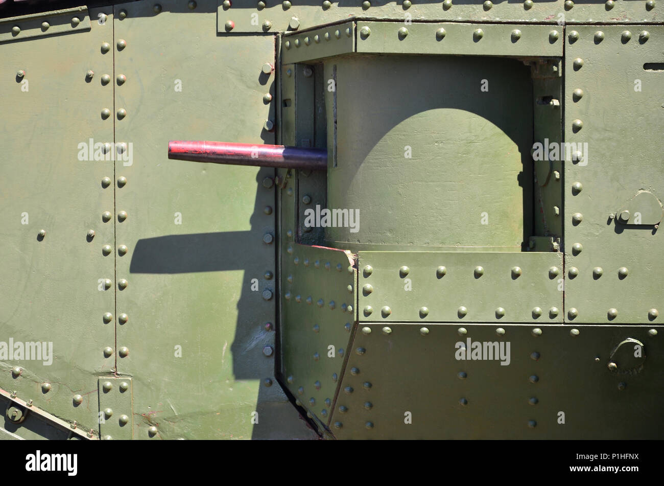 The texture of the wall of the tank, made of metal and reinforced with a multitude of bolts and rivets. Images of the covering of a combat vehicle fro Stock Photo