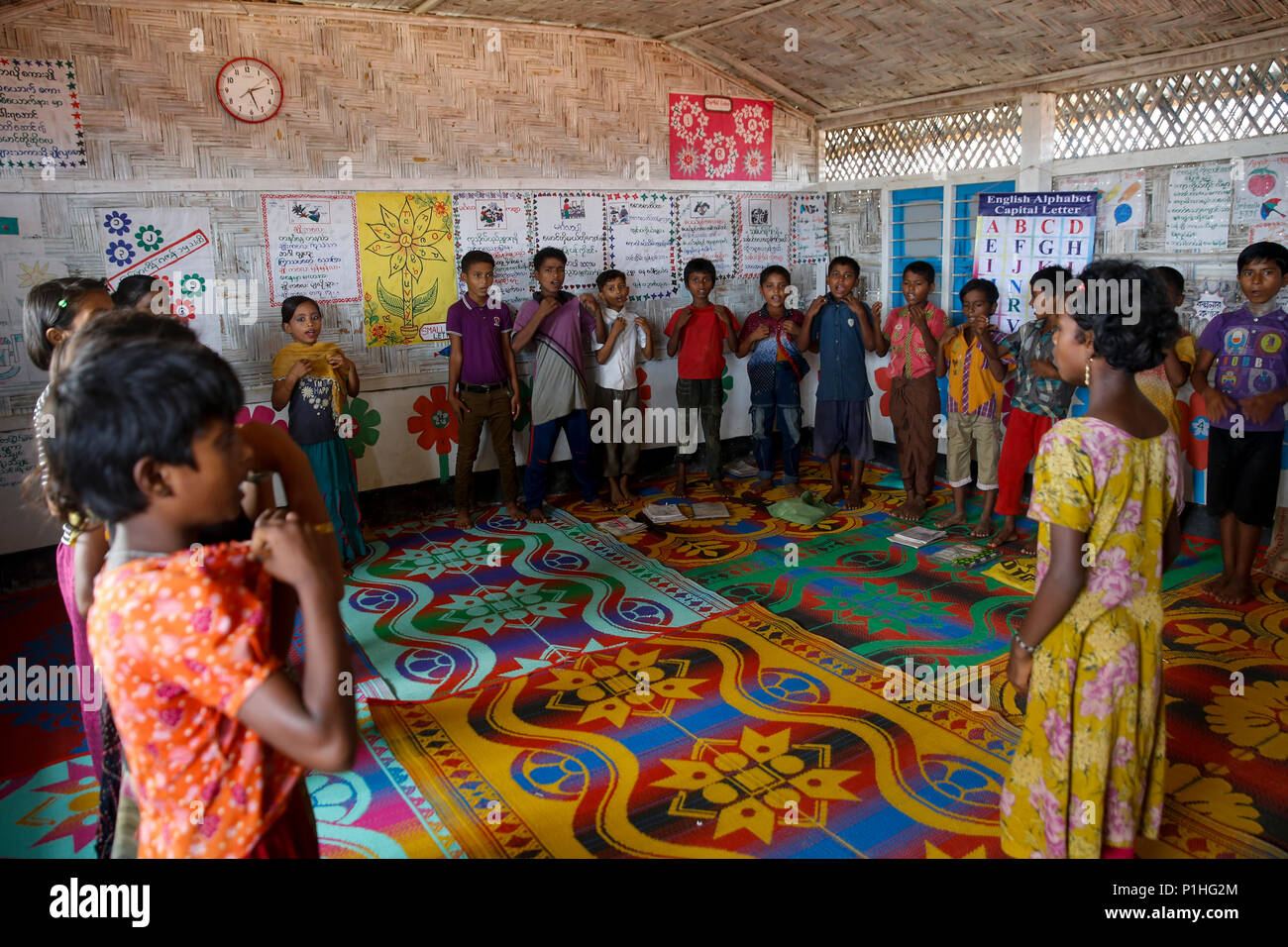 Rohingya refugee children attend class at a temporary school in ...