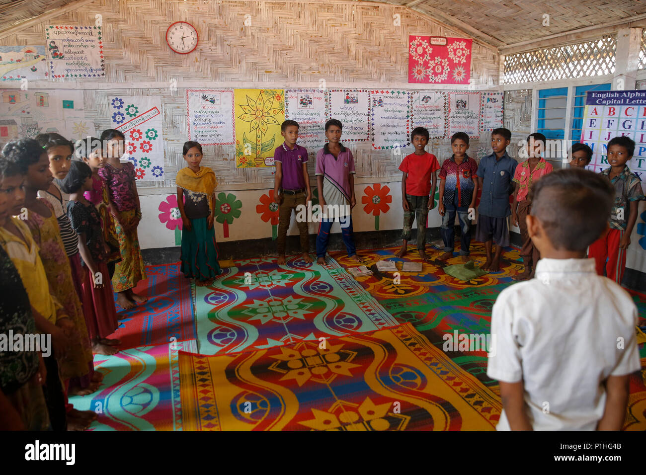 Rohingya refugee children attend class at a temporary school in ...