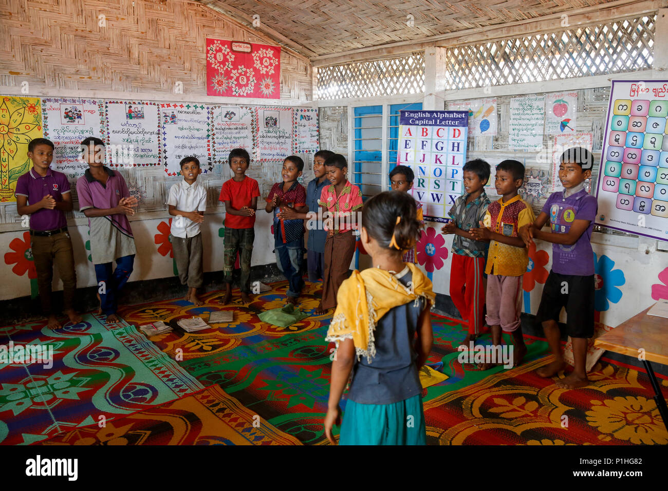 Rohingya refugee children attend class at a temporary school in ...