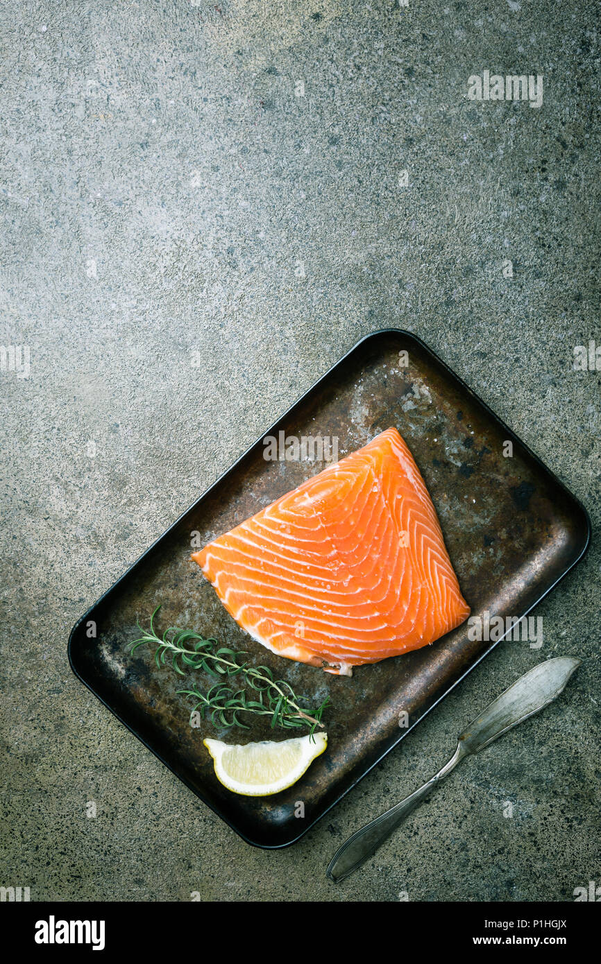 Fresh raw salmon fillet on dark stone background, top view with copy ...