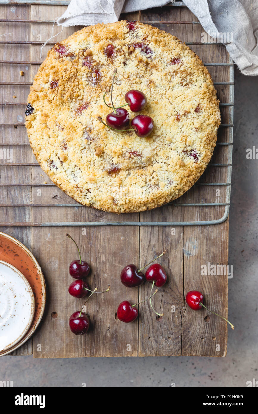 Homemade cherry crumble pie with fresh berries on rustic background ...