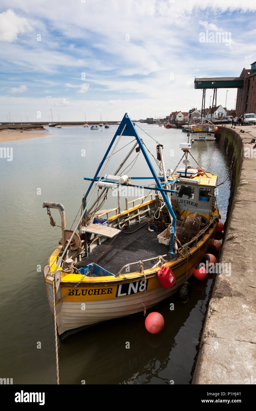 Wells-next-the-Sea, United Kingdom- April 4, 2011: Small fishing trawler moored at the quayside in Wells-next-the-Sea, Norfolk, England. The distincti Stock Photo