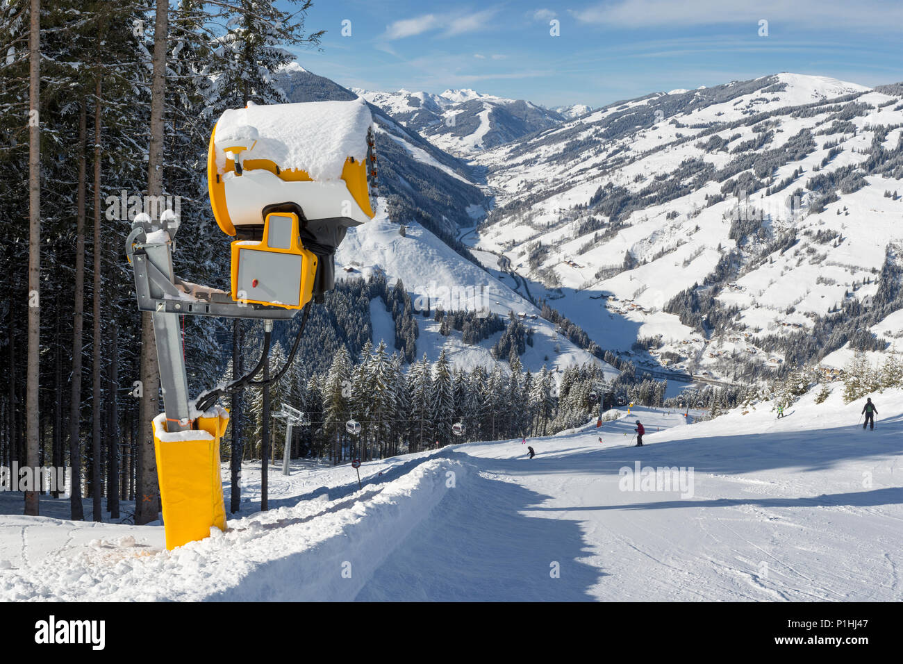 A large snow cannon at the side of a ski slope on a bright sunny day in Zell Am See, Austria. Stock Photo