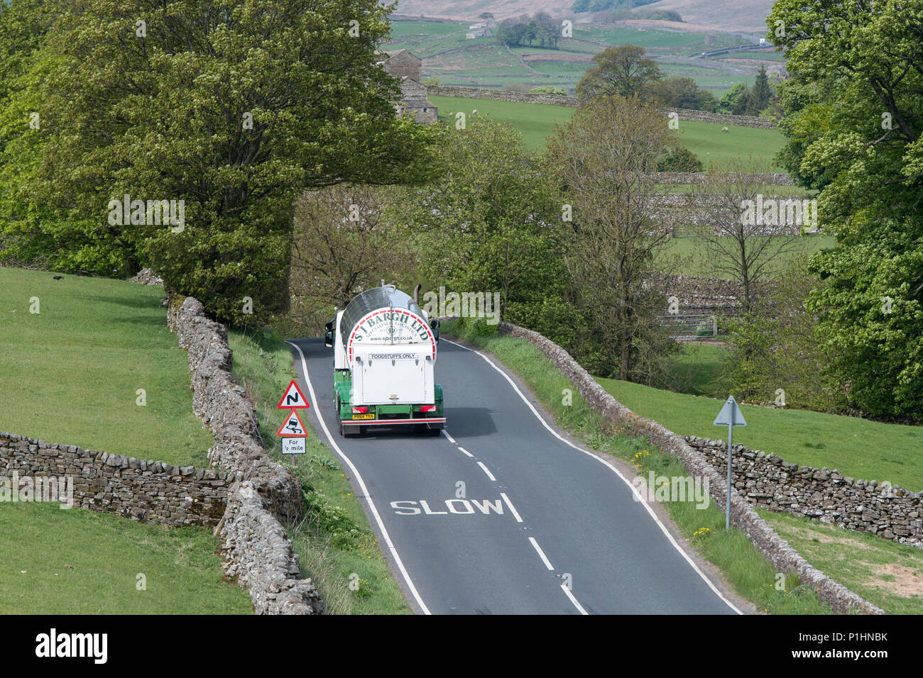 Milk tanker on the road to Hawes and the Wensleydale Creamery dairy where Wensleyday cheese is made. North Yorkshire, UK. Stock Photo