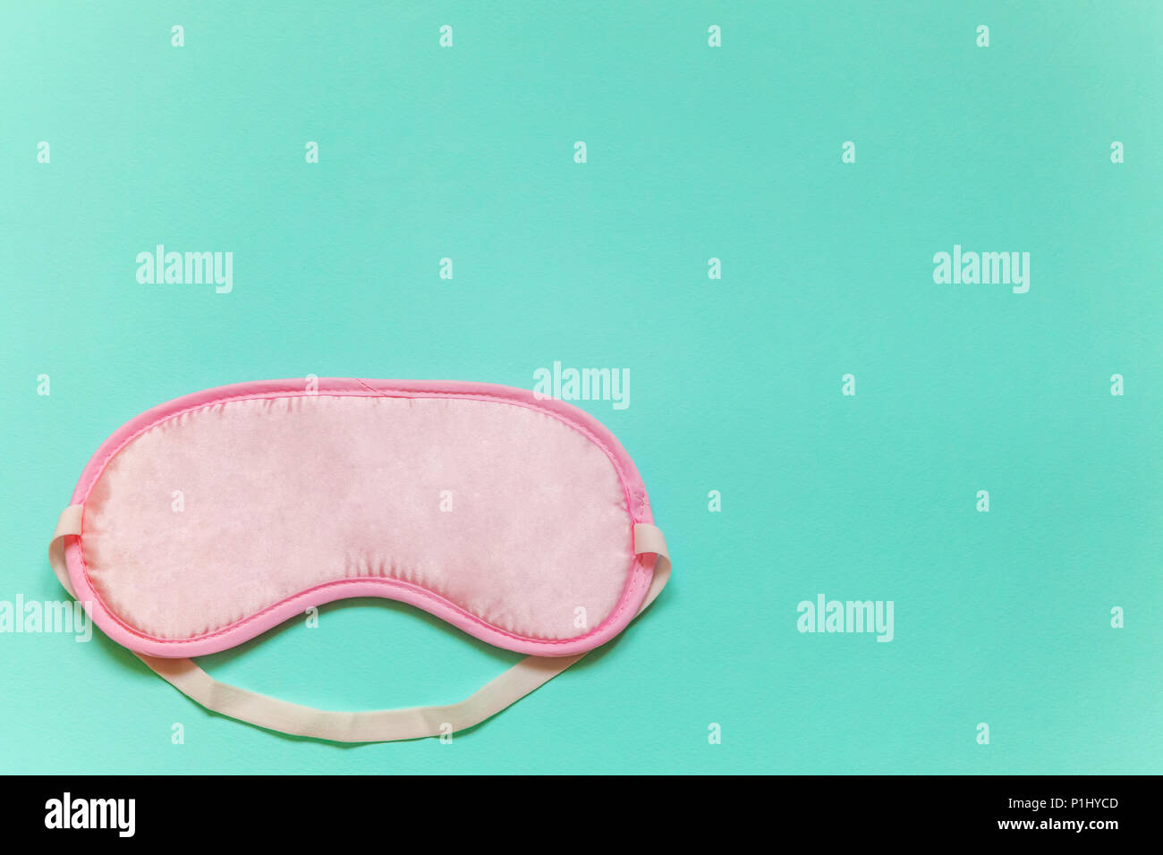 Sleeping eye mask, isolated on blue pastel colourful trendy background. Do not disturb me, let me sleep. Rest, good night, insomnia, relaxation, tired Stock Photo