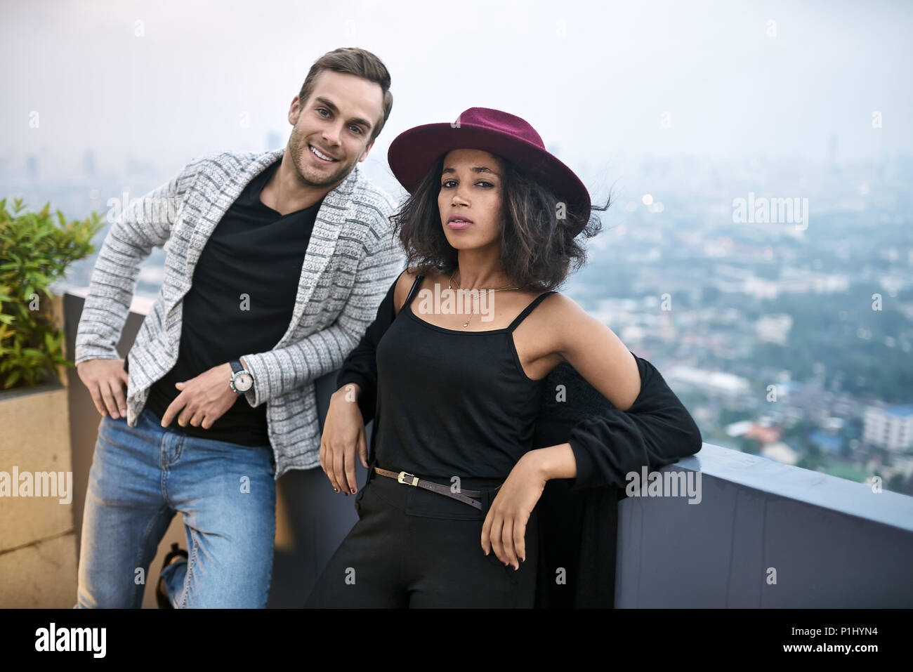 Beautiful interracial couple on balcony Stock Photo