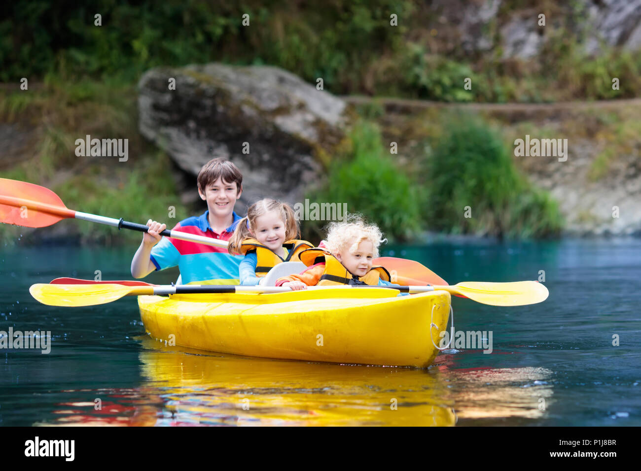 Child with paddle on kayak. Summer camp for kids. Kayaking and canoeing  with family. Children on canoe. Little boy on kayak ride. Wild nature and  wate Stock Photo - Alamy