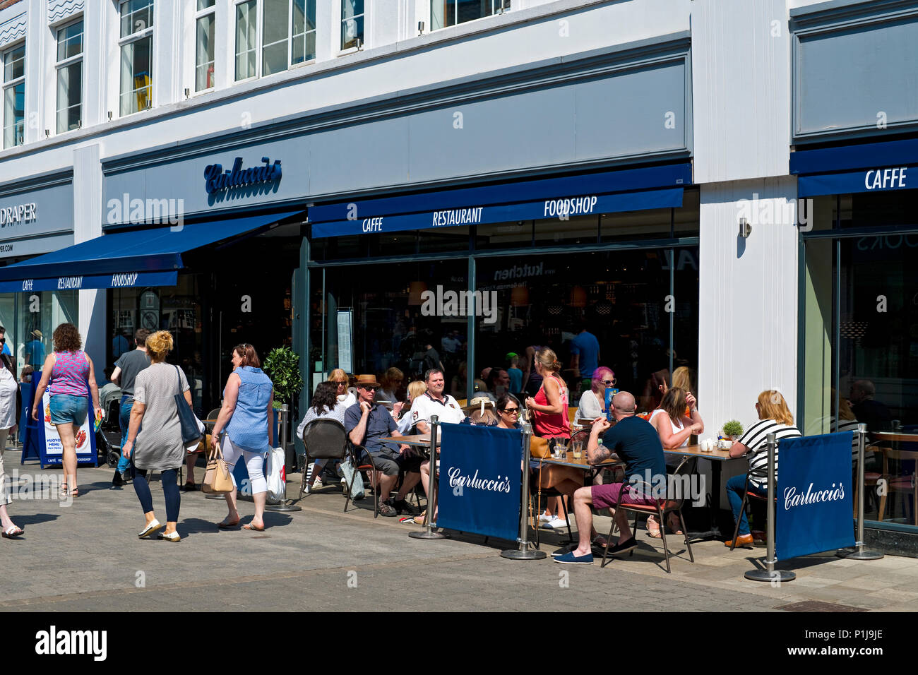 People dining sitting outside Carluccios Restaurant in spring (Now closed) Beverley East Yorkshire England UK United Kingdom GB Great Britain Stock Photo