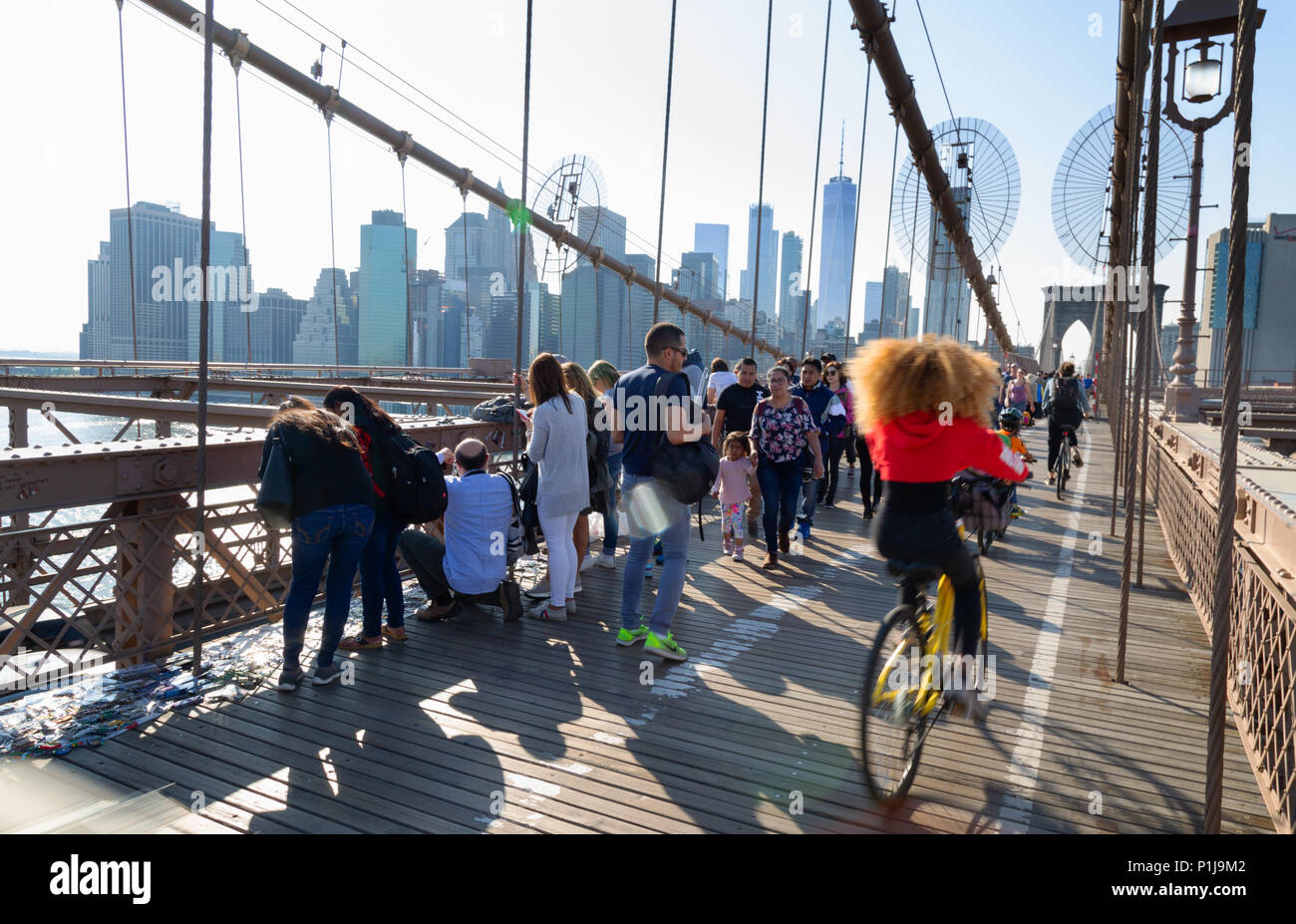 People walking and cycling the Brooklyn Bridge, Brooklyn, New York city USA Stock Photo