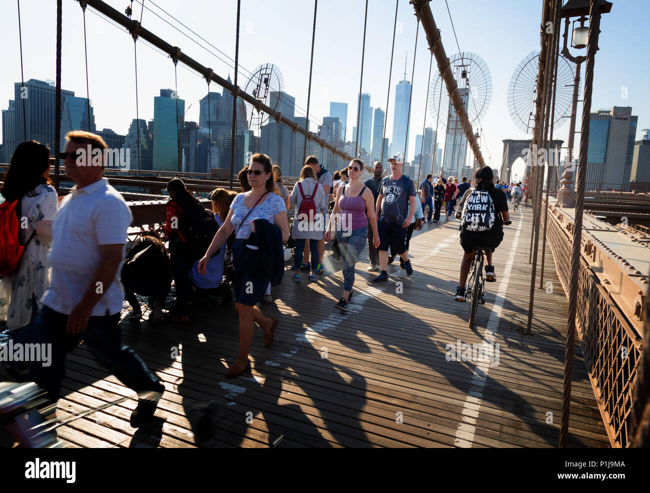 People walking and cycling the Brooklyn Bridge, Brooklyn, New York city USA Stock Photo