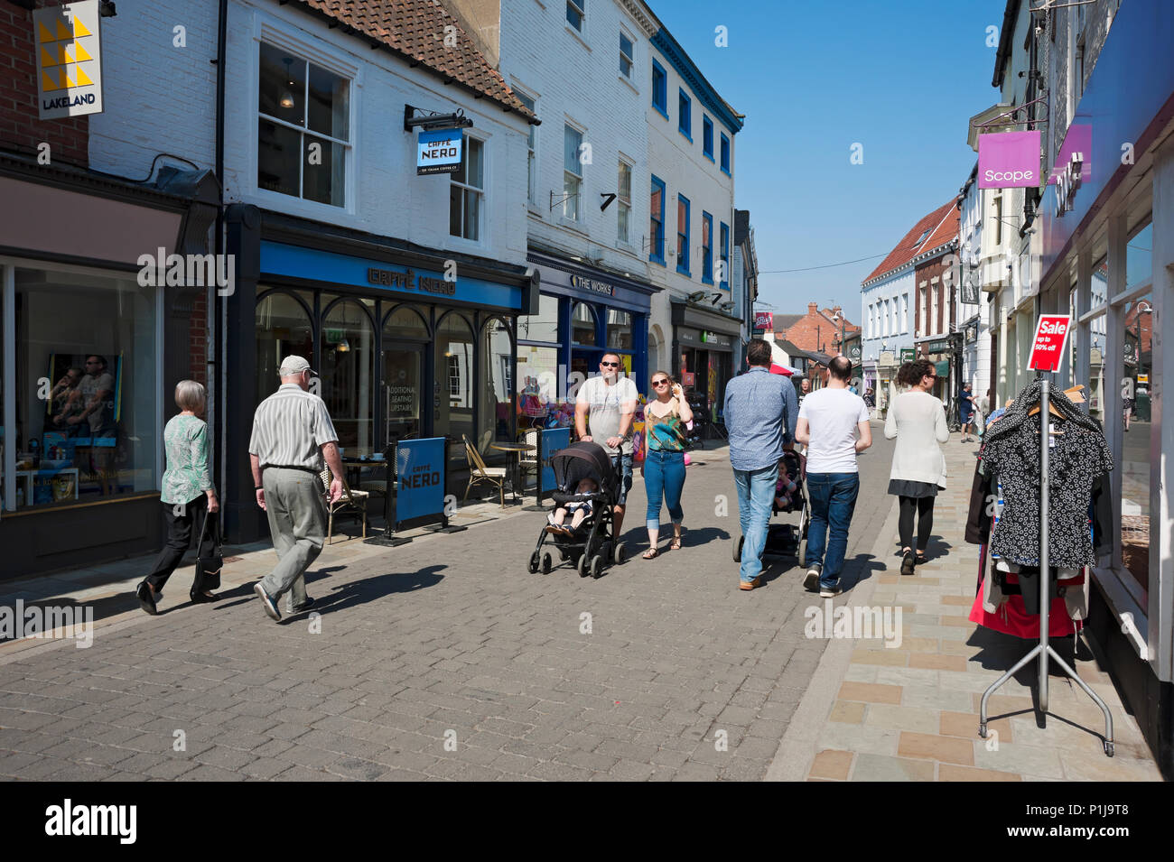 People shoppers shopping visiting the town centre high street shops stores in spring Beverley East Yorkshire England UK United Kingdom Great Britain Stock Photo