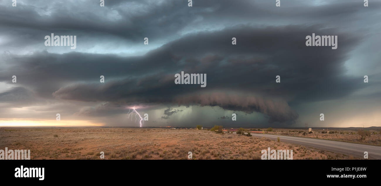 Cloud-to-ground lightning from a thunderstorm with shelfcloud above the New Mexican desert near Artesia (Eddy County) at sunset, USA Stock Photo