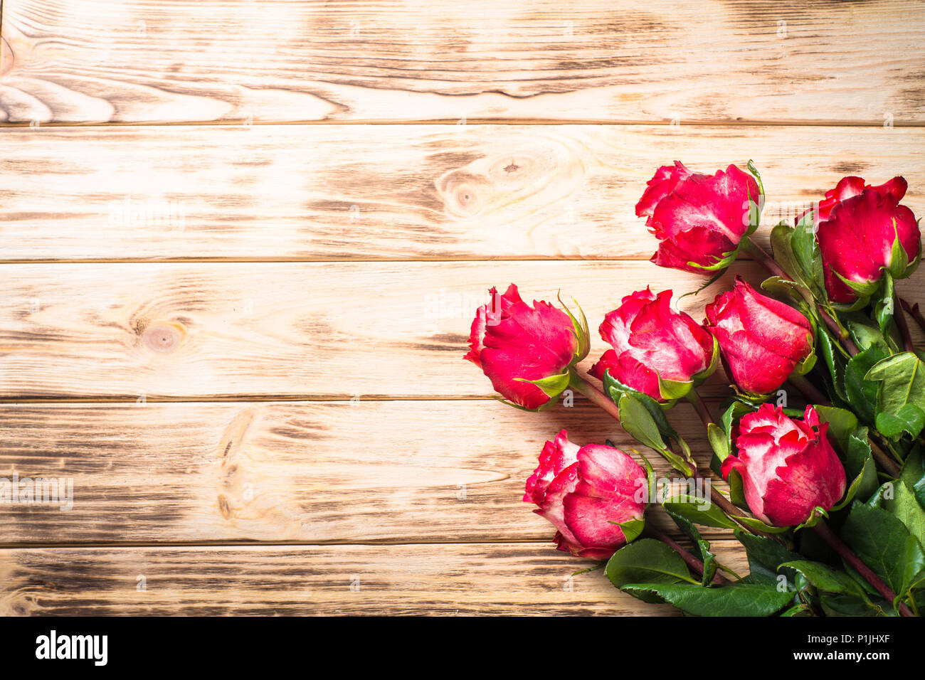 Red rose flower on wooden table. Top view with copy space. Flower background  Stock Photo - Alamy